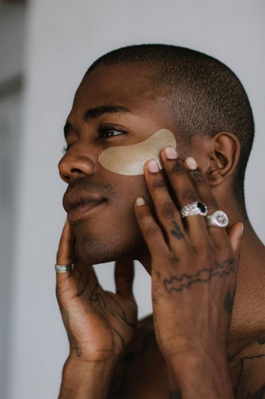 a man applying an undereye mask as one of the most unique gift ideas for him for Christmas