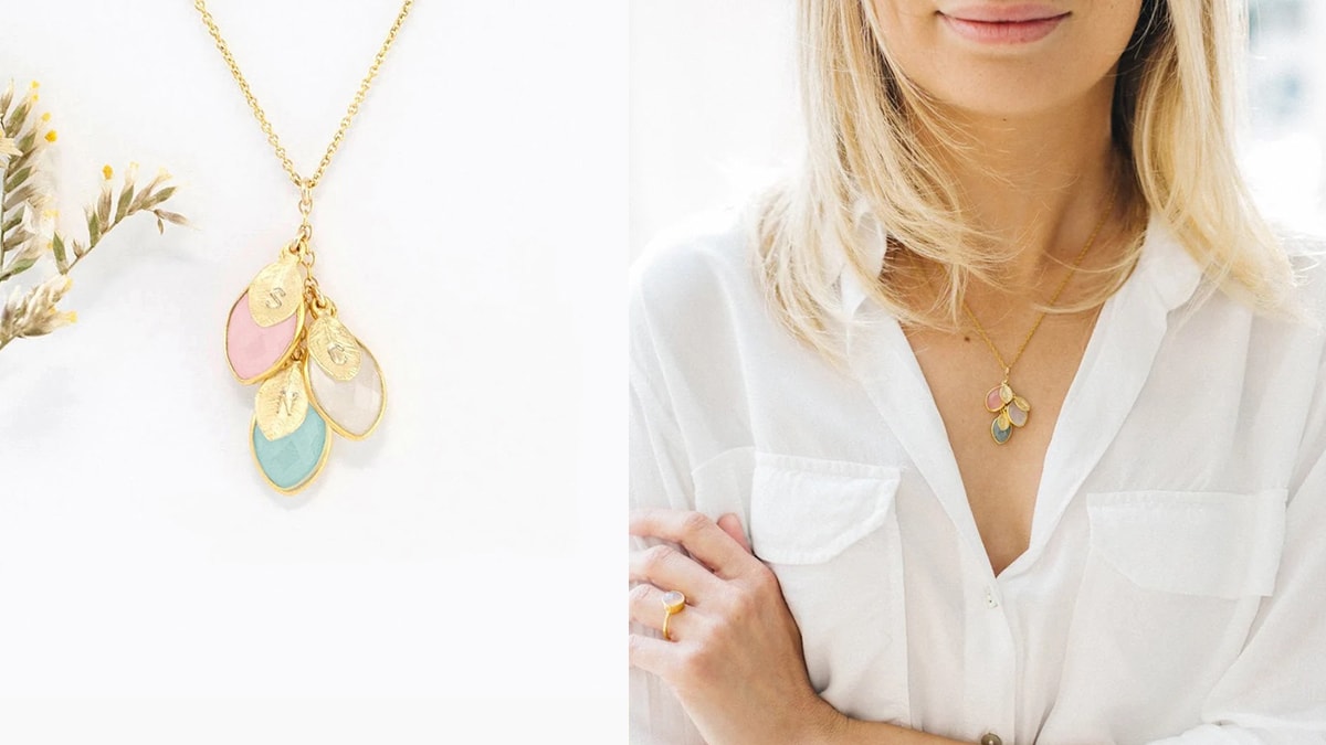 a girl in a white shirt with a birthstone necklace