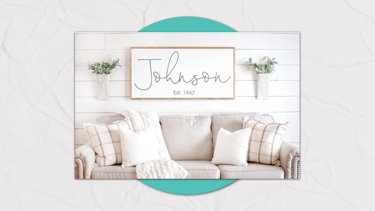 a family name sign mounted on the wall behind the sofa set