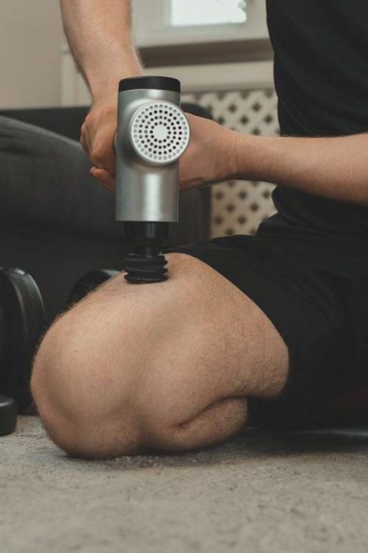 a handheld massage gun as one of the most unique gift ideas for him for Christmas