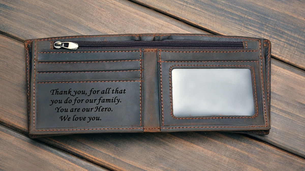 A monogrammed wallet with a custom message engraved on it 