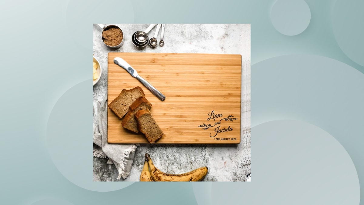 a chopping board engraved with couple names