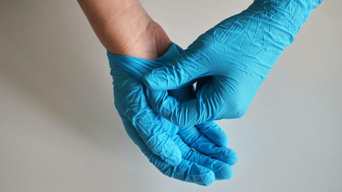 a pair of gloves shown to indicate that you should handle an oil painting wearing gloves 