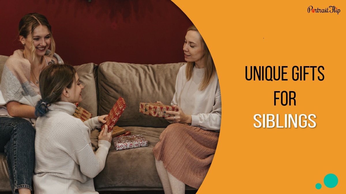 three ladies sitting on the couching opens their gifts