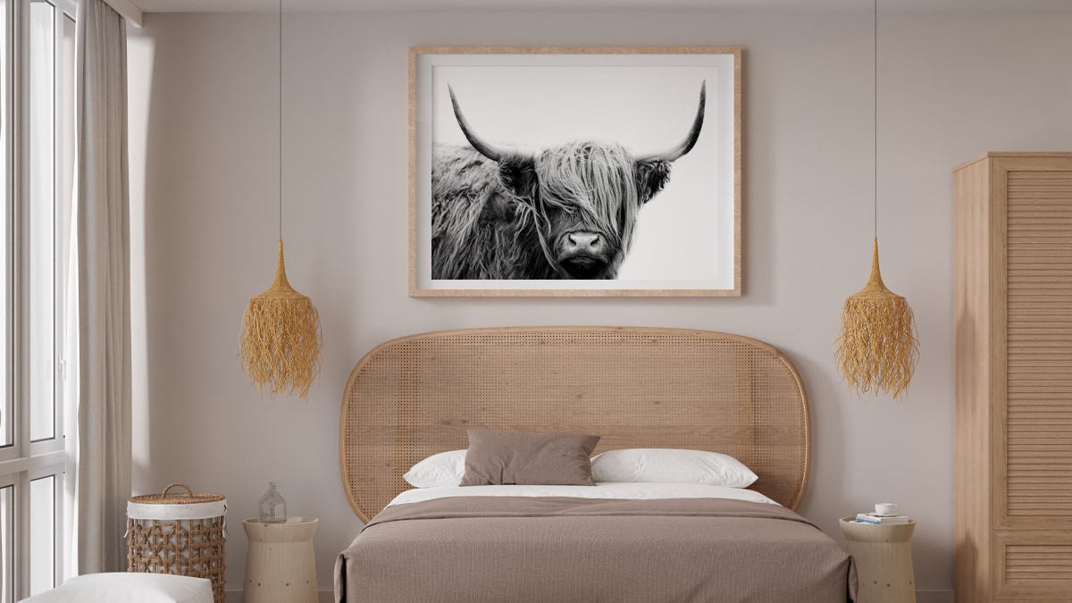 a b&w bull painting on the wall of the bedroom