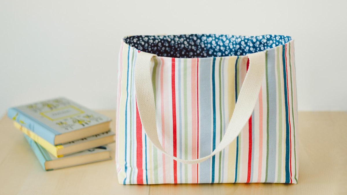 a handmade book bag customized in cloth fabric in colorful prints