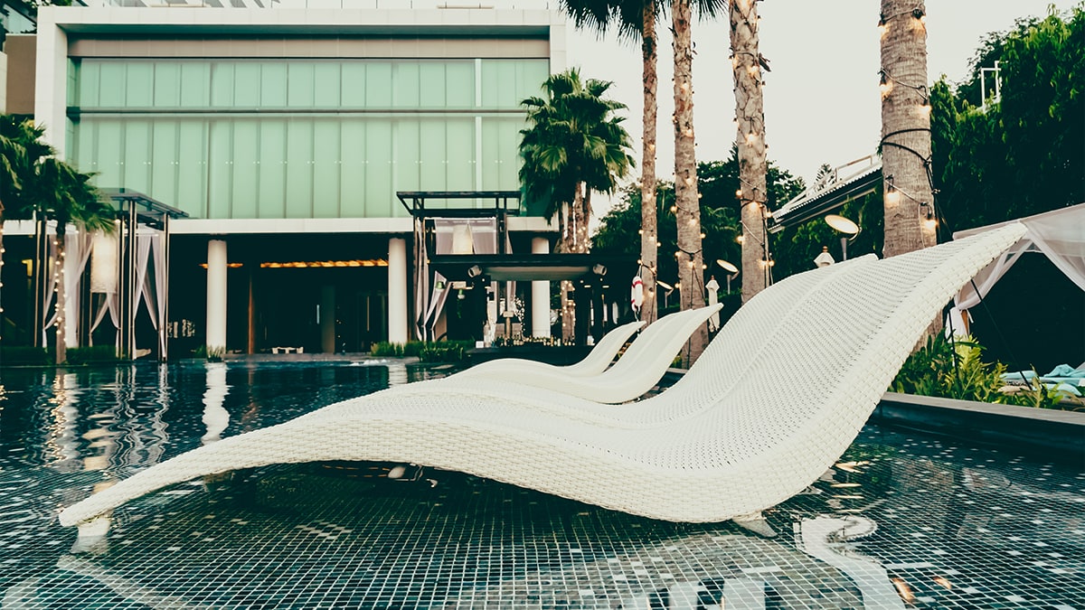 Outdoor view of Airbnb showing shacks next to the pool