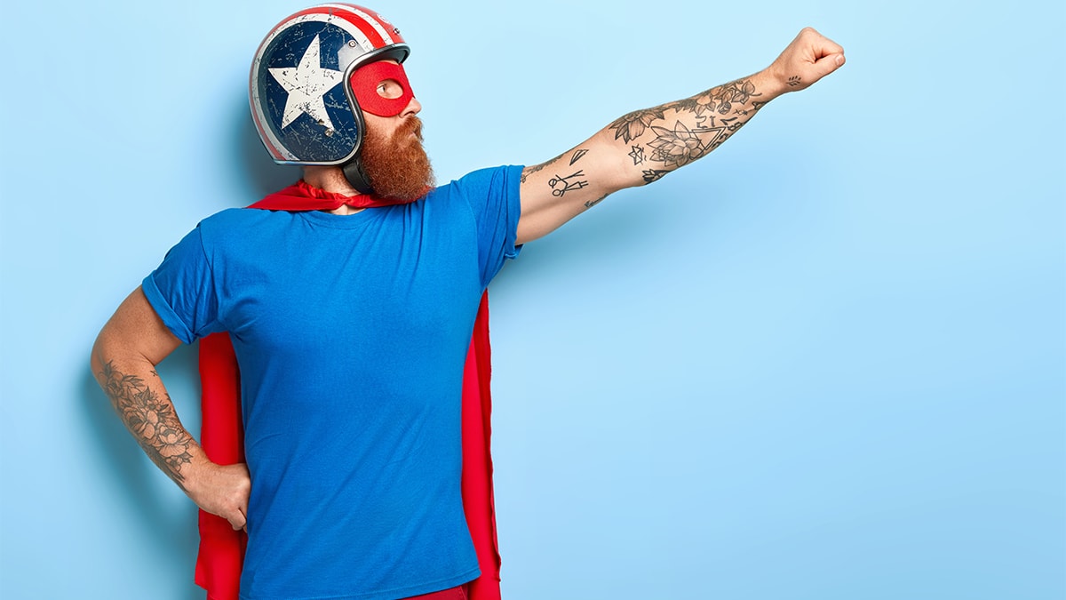 Man wearing captain America design helmet in a superhero pose 