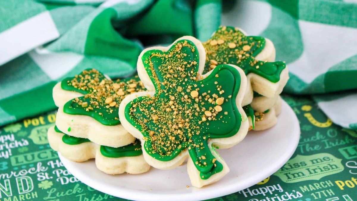 Clover leaf shape cookies place on a white plate