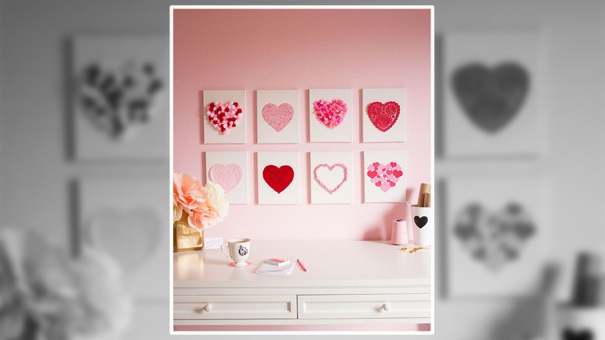 Canvas hanged on the wall with heart shape designed made which is above a table 
