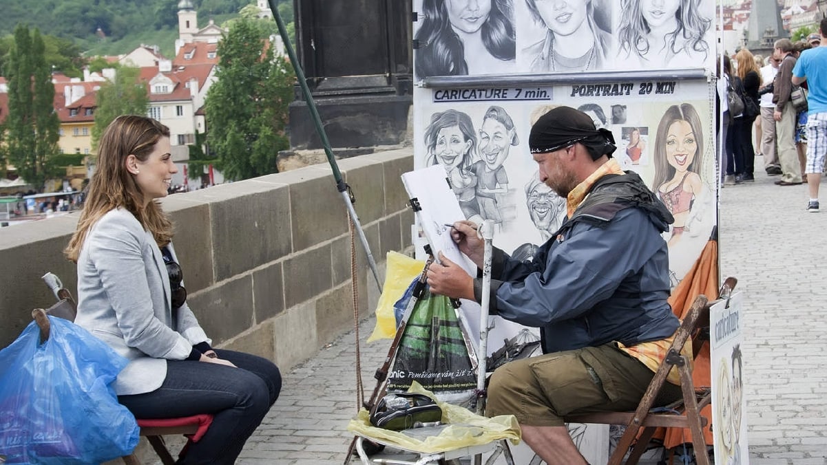 a street artist painitng a lady