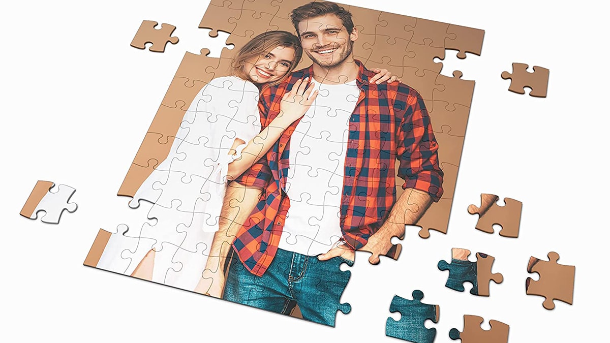 A personalized photo puzzle with a couple picture and few pieces shattered around