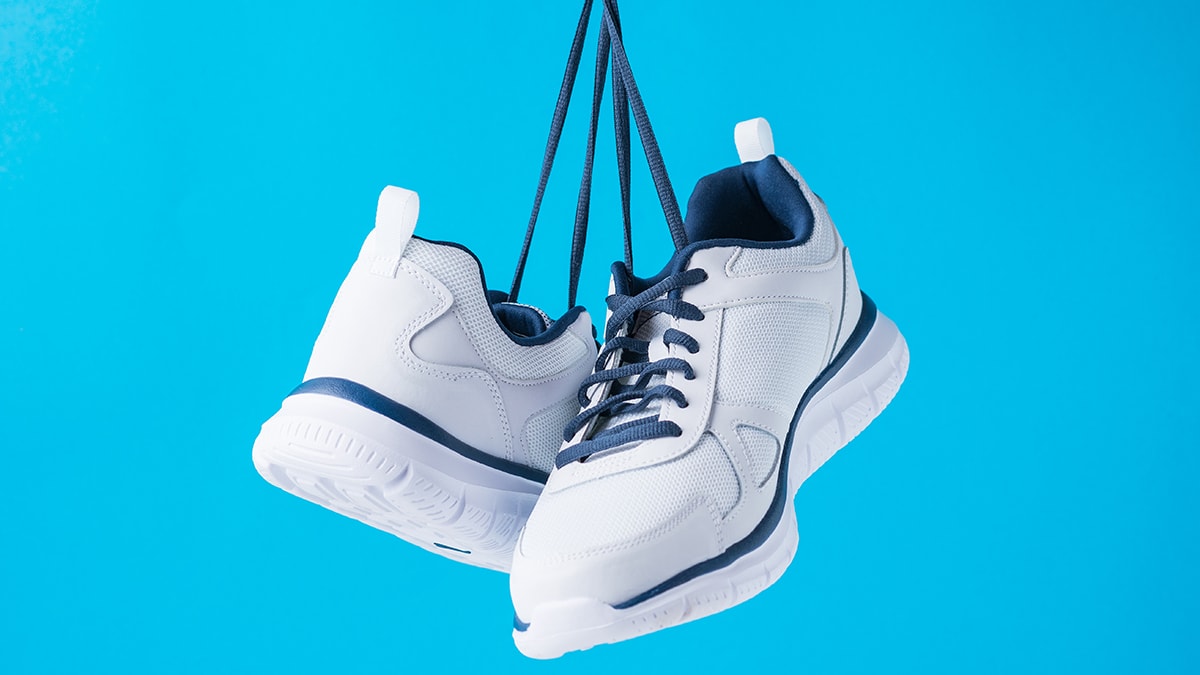 White-blue color shoes hanging by laces