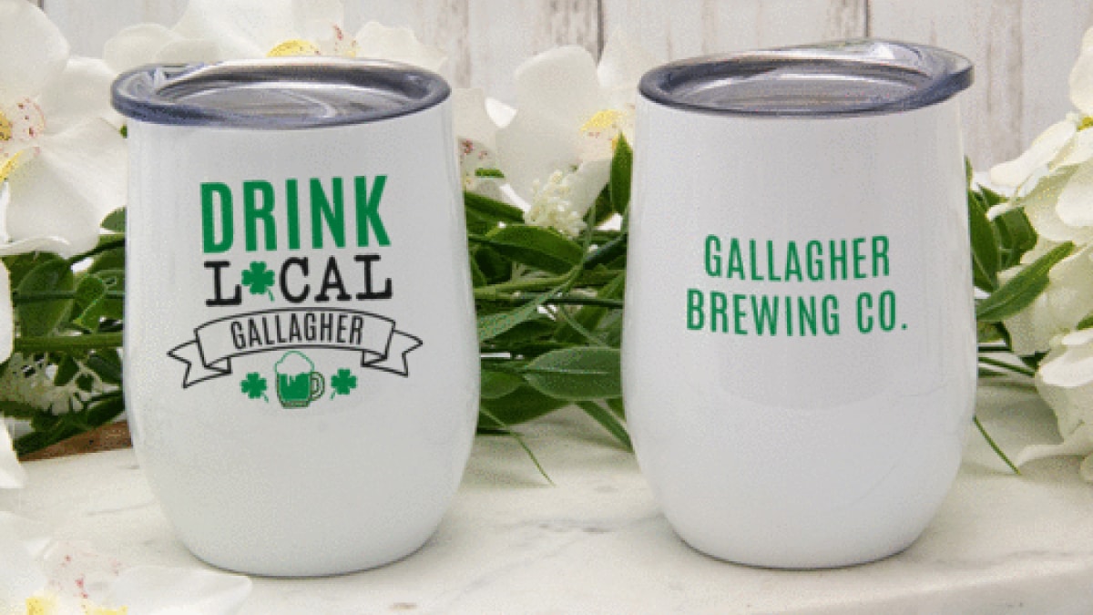 Two white wine tumbler with labels Drink local gallagher with floral background
