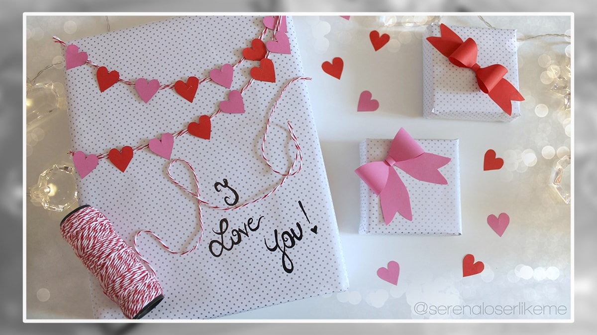 Gifts wrapped with designed papers with a bow and another with heart shaped strings