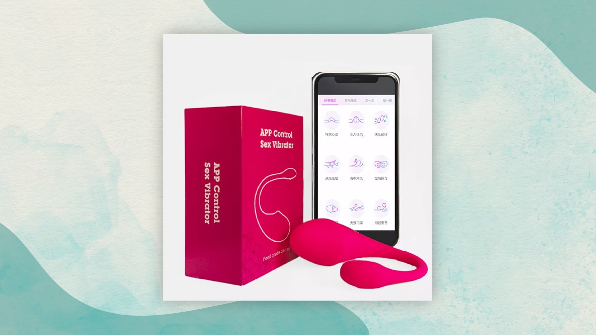 A maroon colored box with" app controlled sex vibrator written on it" alongside a mobile phone in a white background. One of the best gifts for long distance relationships.