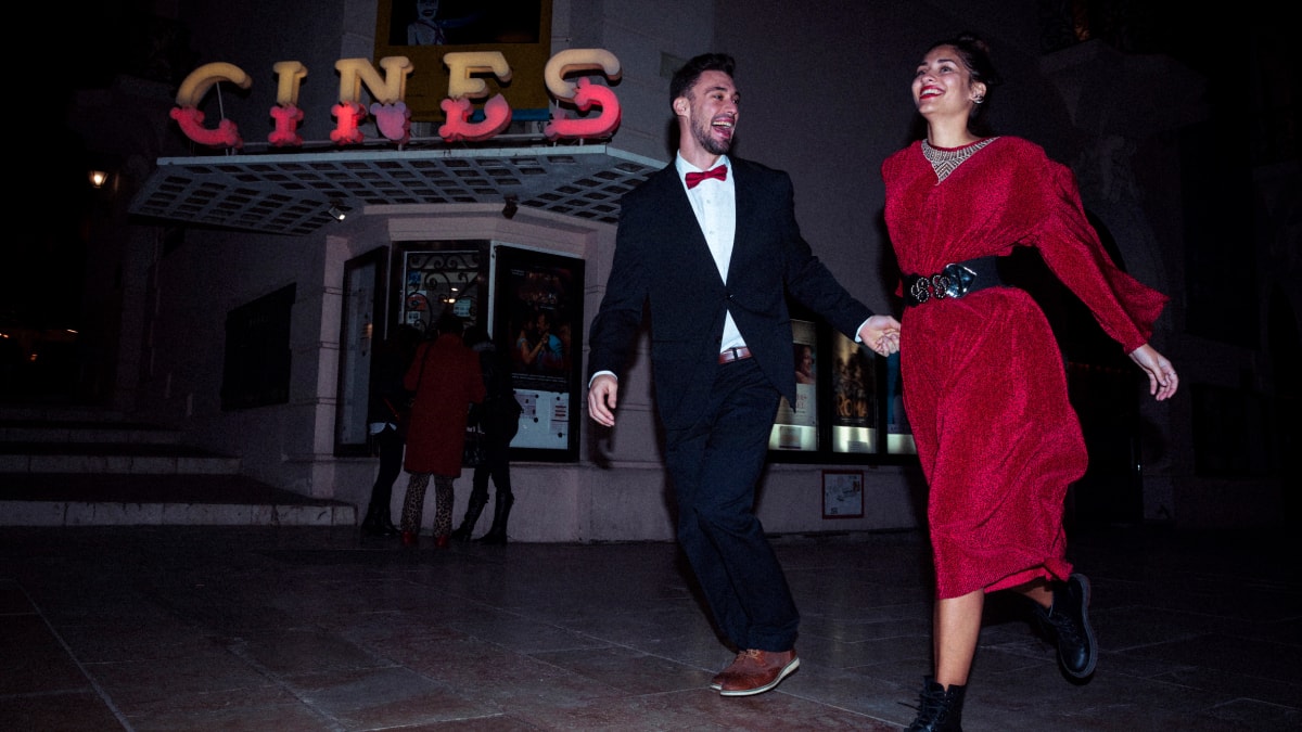 Couple walking outside a Burlesque show and holding hands