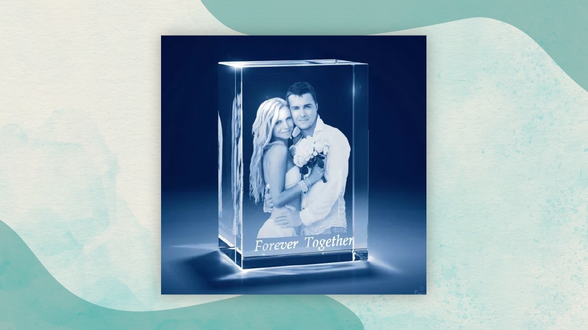 A couple photo in a frame of glass with " forever together" note below it in a dark blue background.