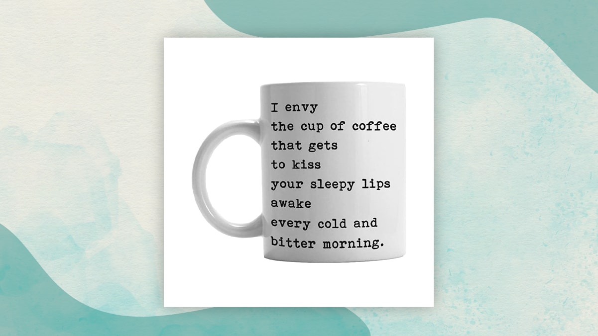 A white coffee mug with a " I envy" message on it in a white background best gifts for long distance relationships, specially for coffee lovers.  