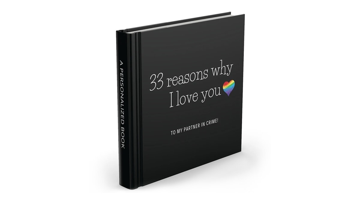 A black book with label of 33 reasons why I love you along with a pride symbol of heart beside.
