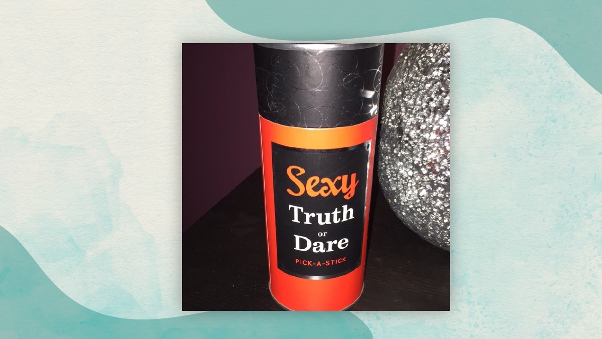 A black and red colored jar of  Sexy truth or dare kept on a table as adventurous gifts for long distance relationships. 