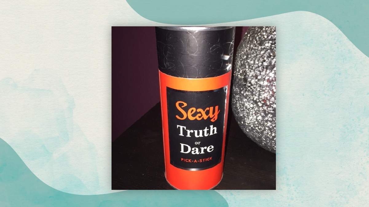 A black and red colored jar of Sexy truth or dare kept on a table as adventurous gifts for long distance relationships.