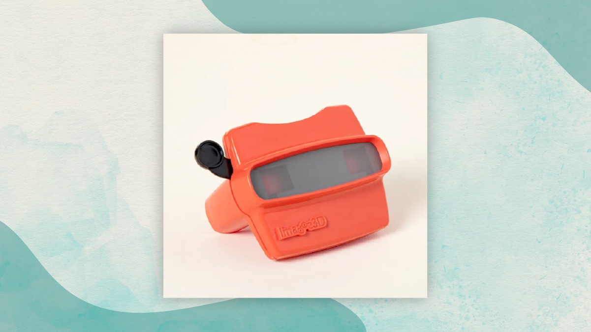 A red reel viewer with a black lever in an  off-white background as gifts for long distance relationships. 