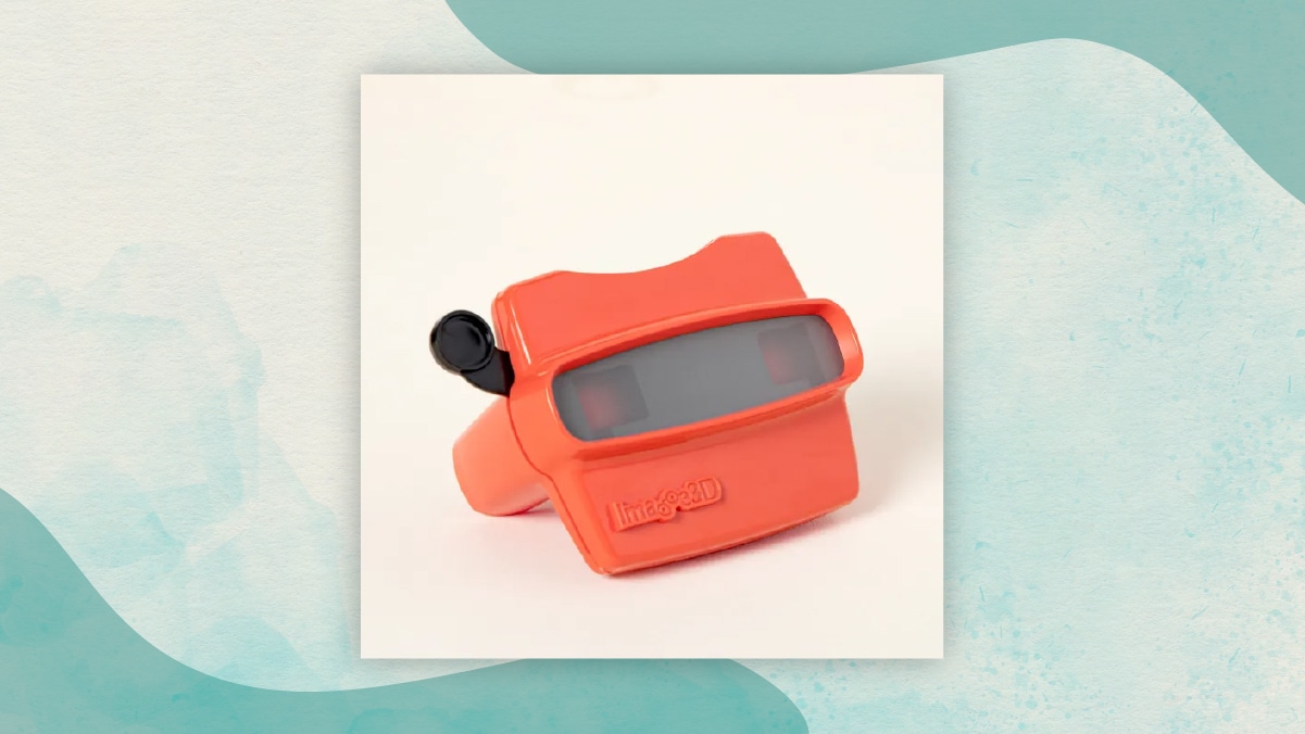 A red reel viewer with a black lever in an off-white background as gifts for long distance relationships.
