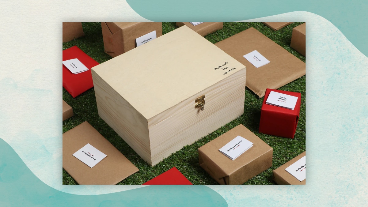 A wooden box with" Made with love"  written on it with black ink surrounded by 13 small brown and red boxes with white colored notes stick on their top. 