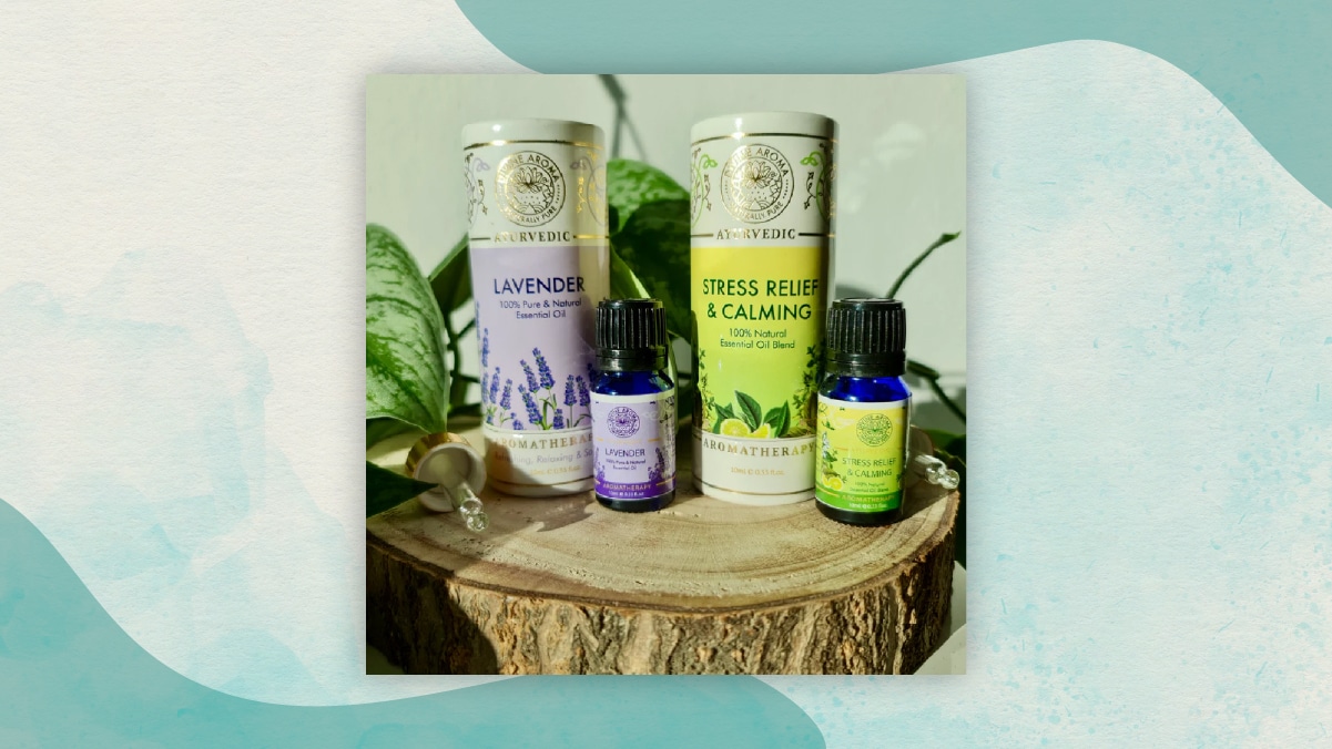 Two big and two small bottles of lavender, stress relief and calming essential oils kept on a flat wooden top as gifts for long distance relationships. .  