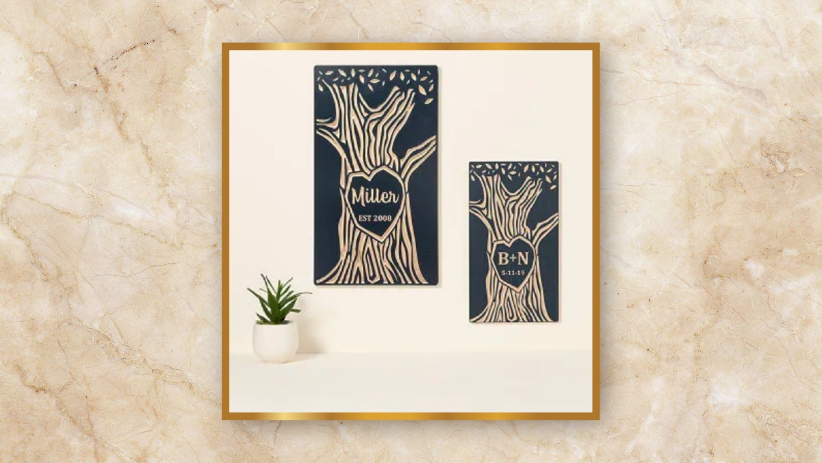 A tree carving art as personalized wedding gifts hung on an off-white colored wall. 