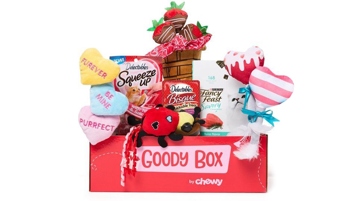 A red goody box with a lot of chewy goods in a white background. 