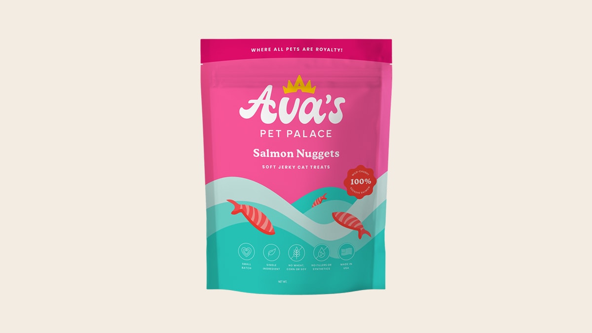 A pink and blue colored packet of salmon nuggets in an off white background. 