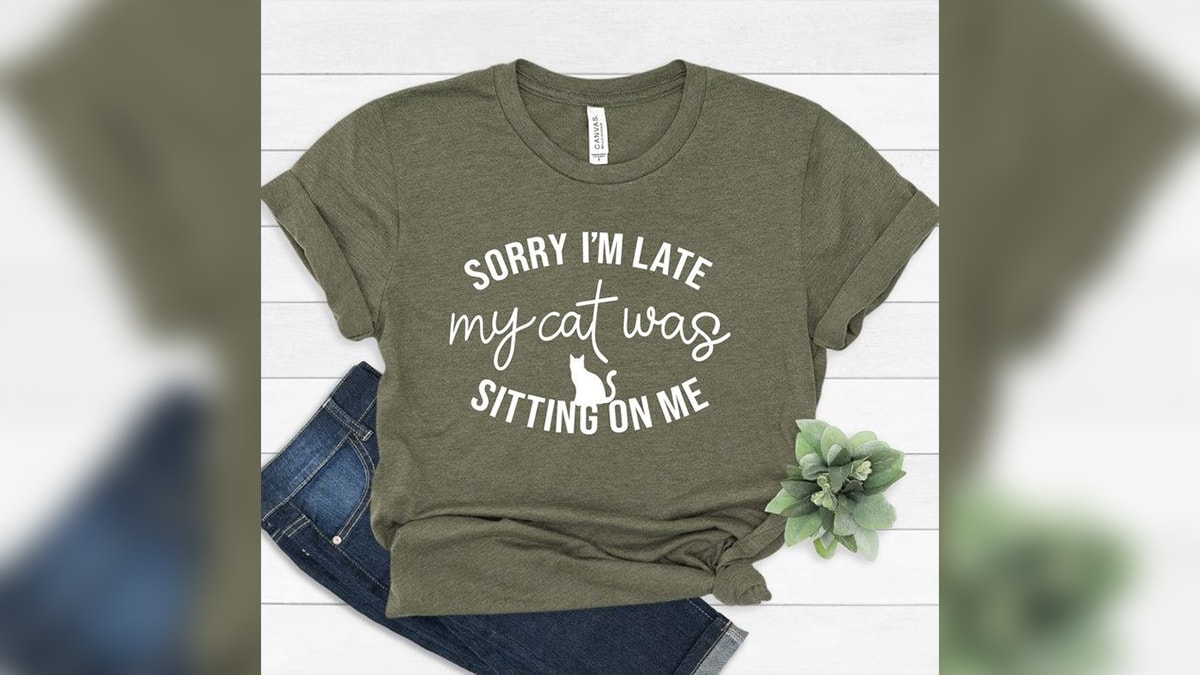 A cat mom top with quotes written on it . 