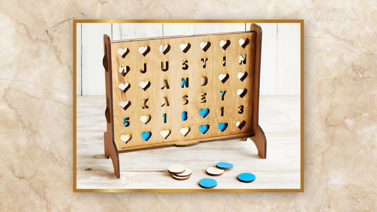 A wooden frame with alphabets kept on  a wooden table as personalized wedding gifts. 