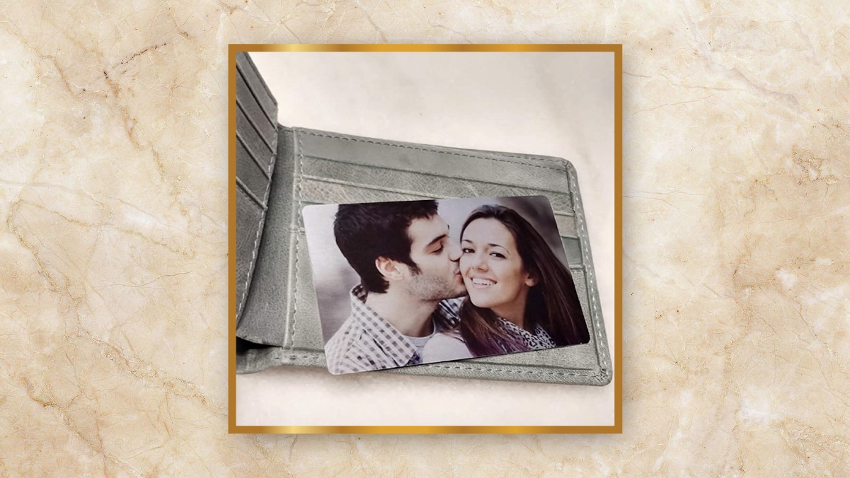 A wallet with a photo of a man kissing a woman on it. 