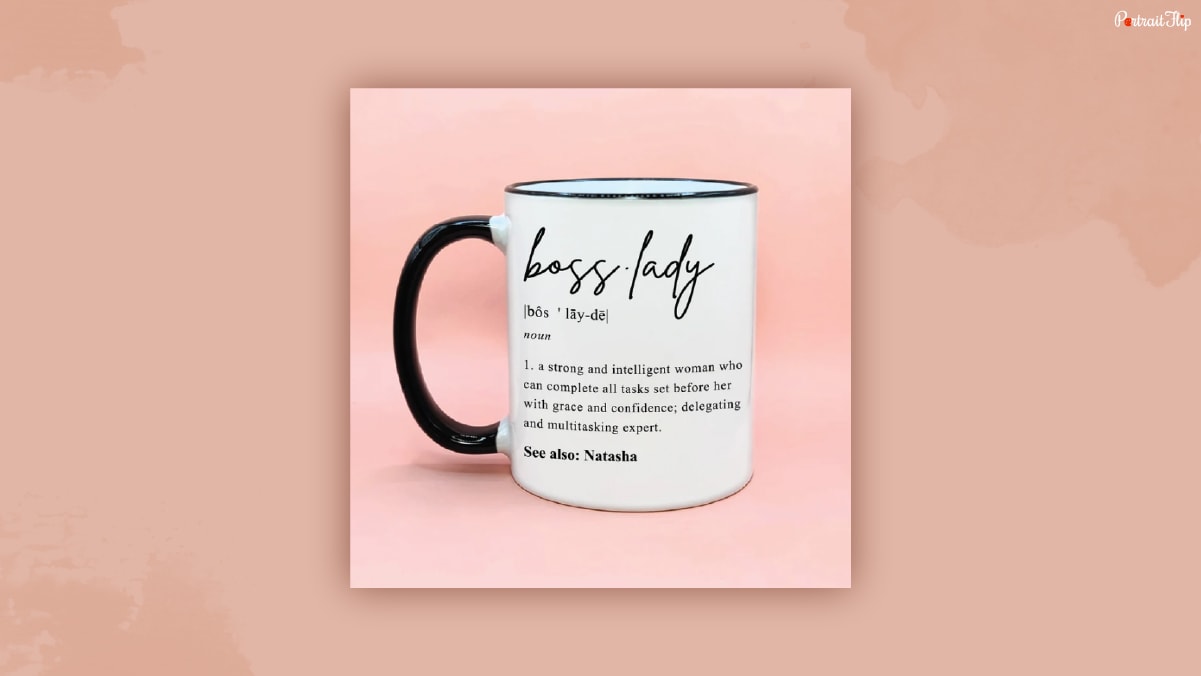 A mug with printed text boss lady and the meaning that it says.