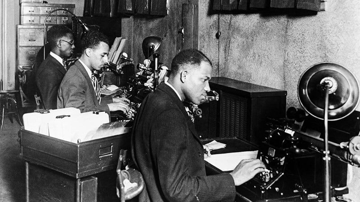 black people from harlem using typewriter 