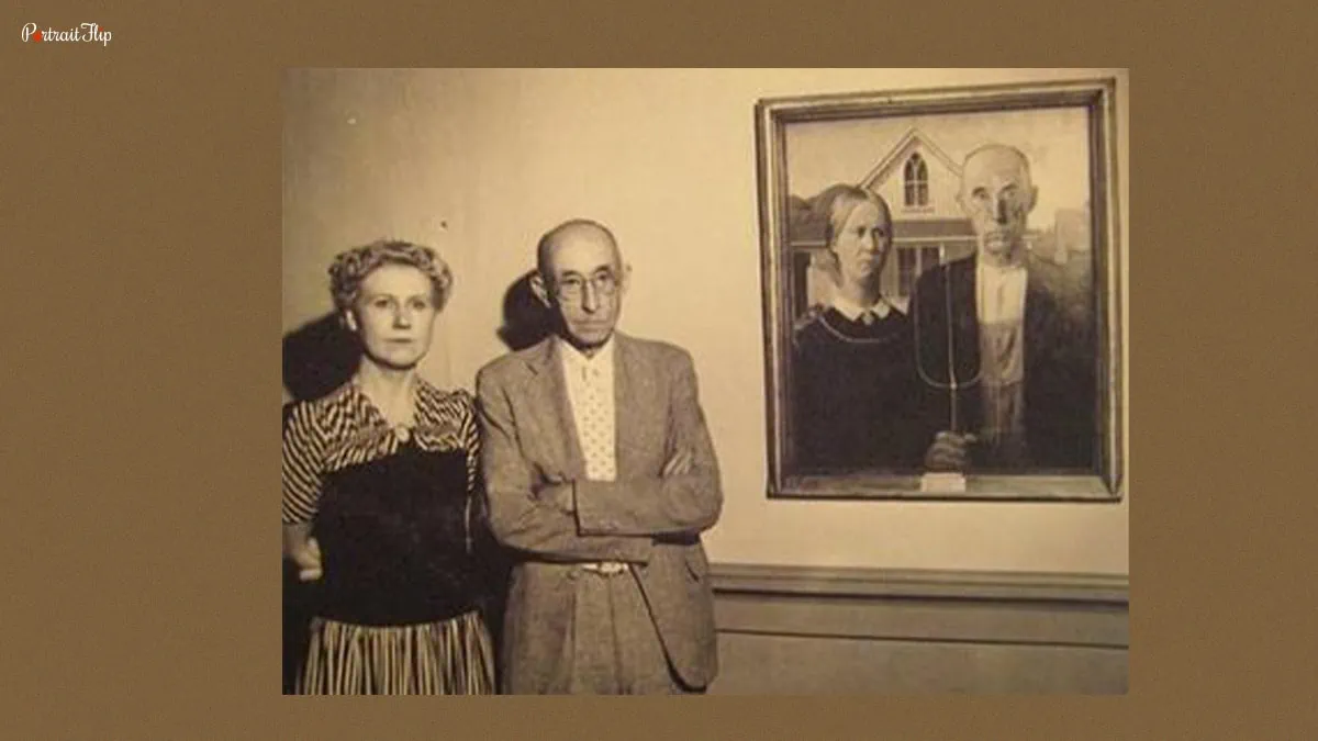 Dr Mckeeby and Nan Wood standing beside the American Gothic painting. 