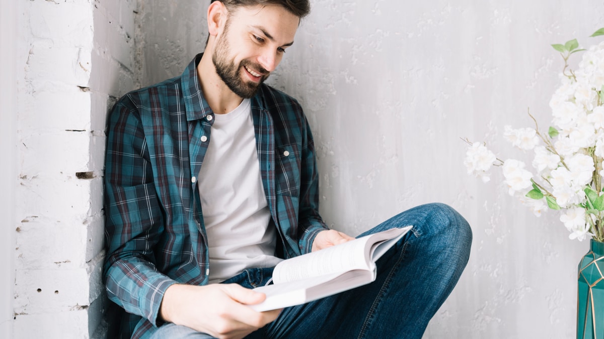 A man reading a book which can be a gifts for gay men.