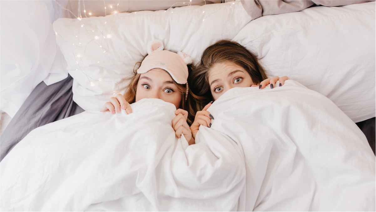 Two ladies under the handmade blanket