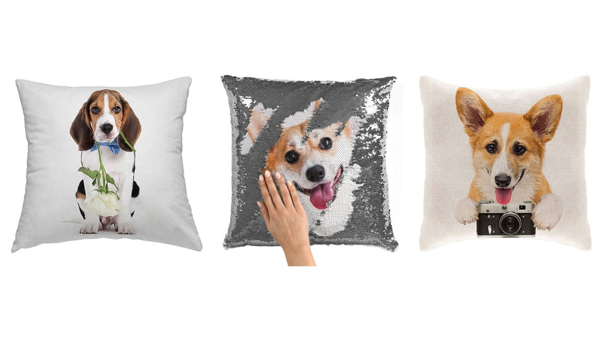 Pillows with three different dogs on them are placed on a white background. 