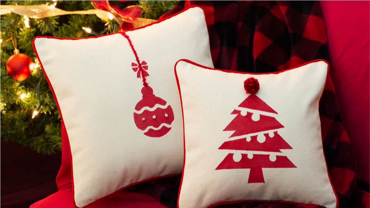 Two printable Christmas pillows are placed on the cushion bed
