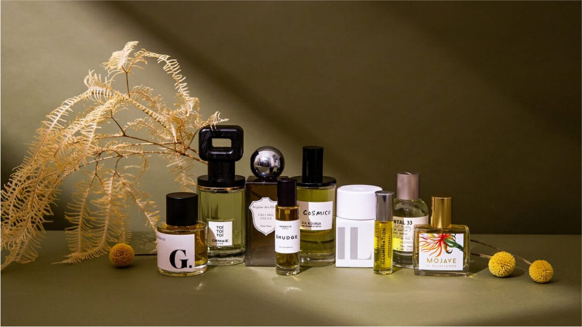 Different types of scents are kept on a brown surface and background. 