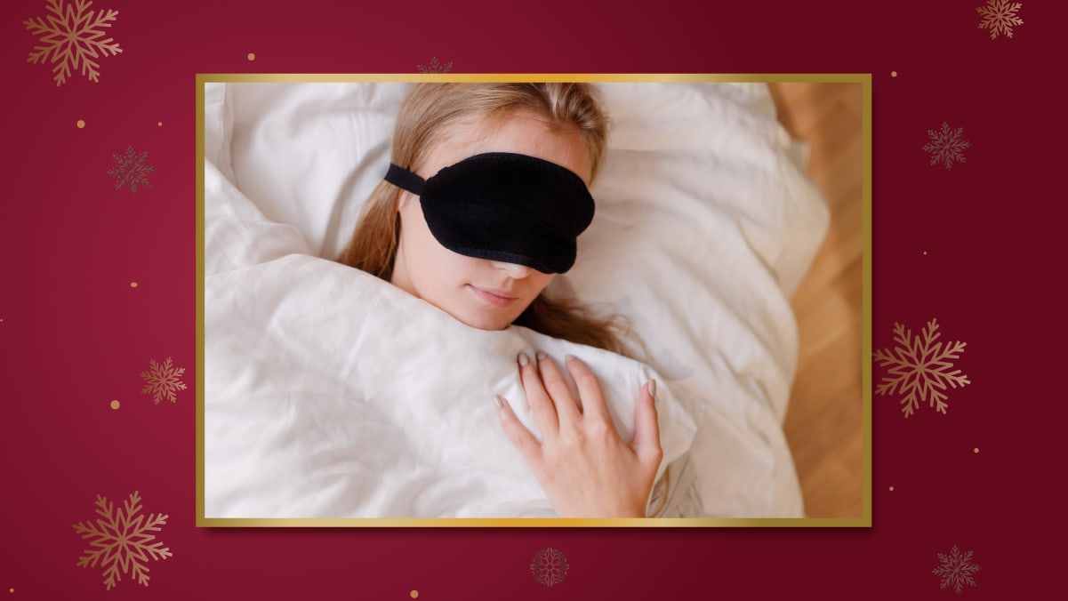 a girl has put eyes mask is sleeping in a bed