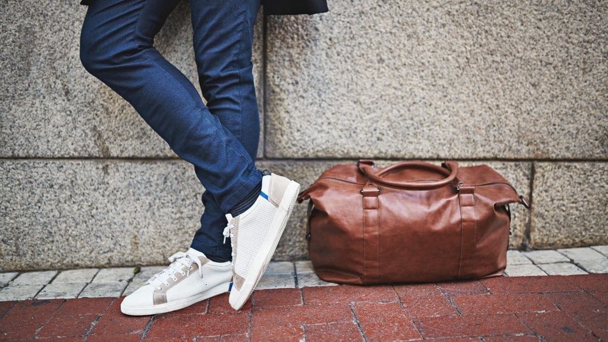 a man standing with a duffle bag that is foldable as a Christmas Gifts For Brother-In-Law