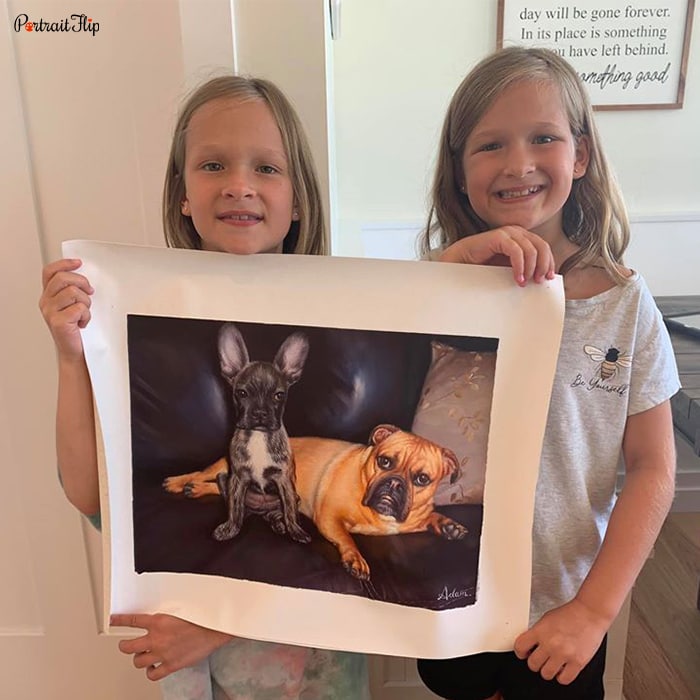 Photo of two girls holding dog portraits from each end