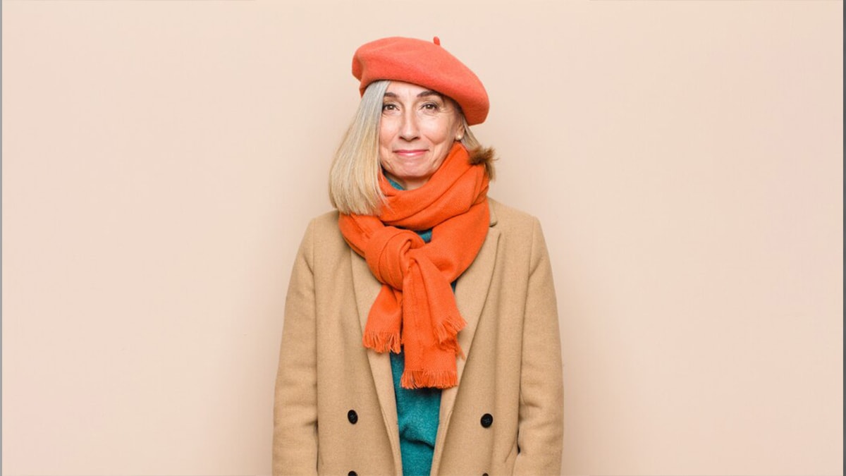 An old woman wearing a comfortable shawl as a mother's day gift idea.