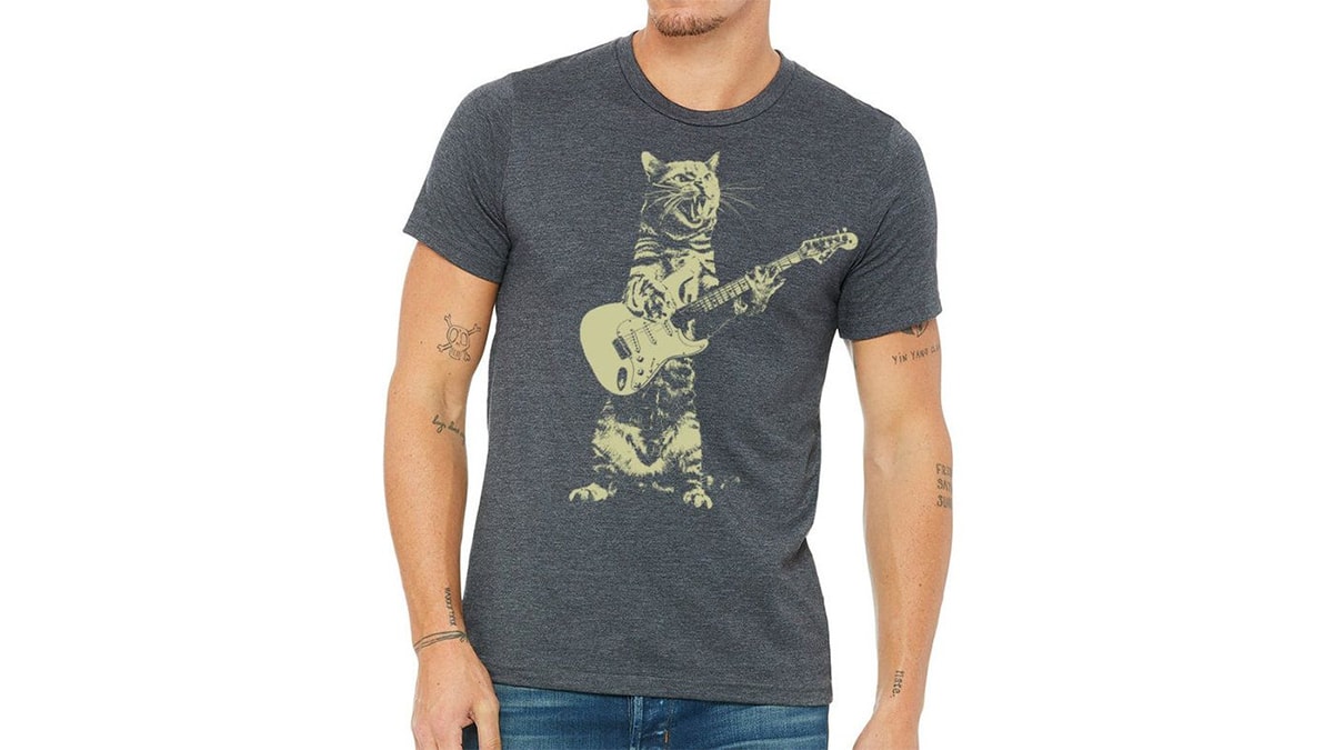 A man wearing a cat rockstar t-shirt in a white background. 