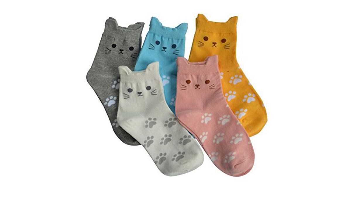 Five socks of different colors with cat shaped faces in white background. 